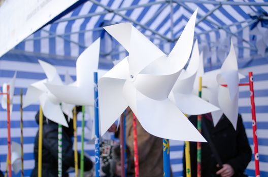 paper windmills sell in outdoor street donation charity event for poor lonely kids.