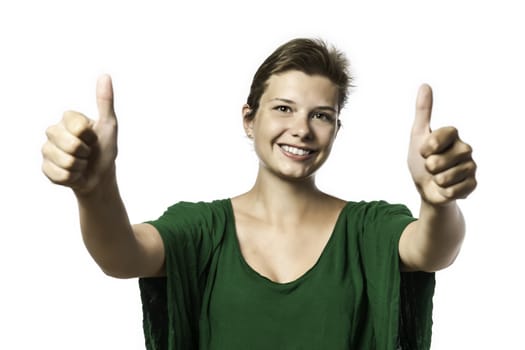 Pretty girl helds her two thumbs up, isolated on white background