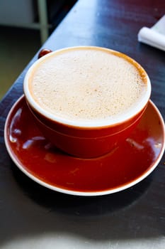 A mocha is served in a ceramic mug at a restaurant that makes amazing coffee and latte.