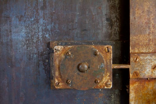 A door handle lock detail on an old building in the doorway to a restaurant.