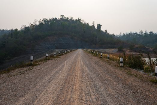 Dirt Road on the Dam in Countryside.