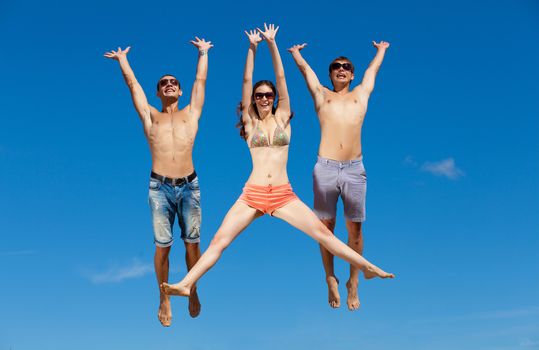 Happy group of friends at the beach