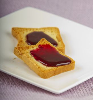 Toasts with jam over a white plate