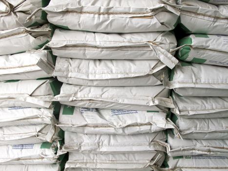 Pile of white paper sacks in warehouse