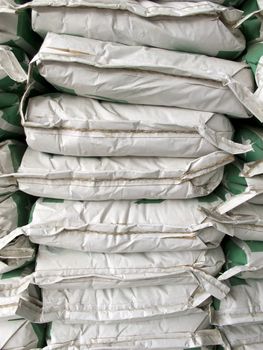 Pile of white paper sacks in warehouse