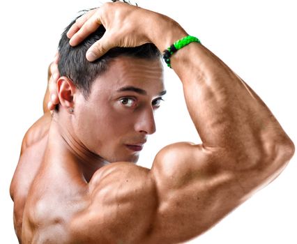 Closeup of young man with muscular arm in front of his face, looking in camera, isolated on white