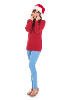 Happy Asian Christmas woman wearing santa hat. Christmas woman portrait of a cute, beautiful smiling Asian Chinese / Japanese model. Full body isolated on white background.