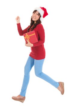 Christmas woman running and holding gift wearing Santa hat. Standing in full body isolated on white background. Smiling woman portrait of a beautiful Asian model.