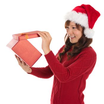 Christmas Gift - Asian woman opening gift happy face, Young beautiful smiling woman in Santa hat. Funny cute photo of Asian woman isolated on white background