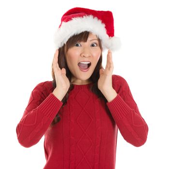 Shocked Asian Santa woman shouting isolated over white background. Asian female model.