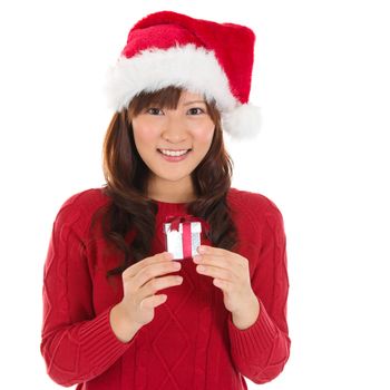 Santa hat Christmas woman holding Christmas gift smiling happy and excited. Cute beautiful Asian santa girl isolated on white background.