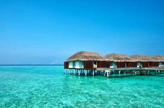 Beautiful beach with water bungalows at Maldives