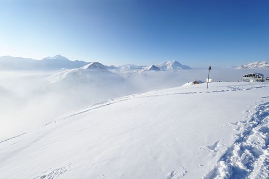 Mountains in clouds with snow in winter, Val-d'Isere, Alps, France