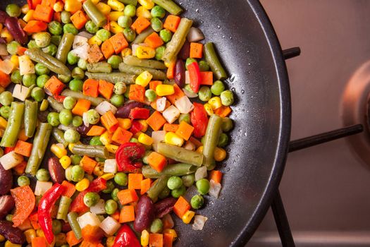 High angle view of pan with vegetables on kitchen stove 