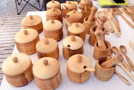 wooden handmade sugar basin spice mortar and other kitchen utensil tools sold in outdoor street market fair.