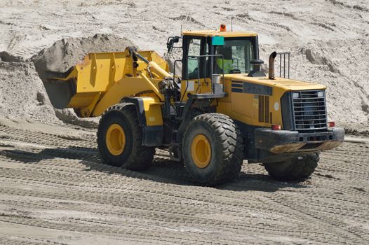 Big yellow bulldozer working on construction site
