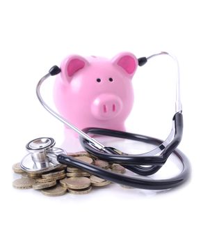 concept of listening to the money market, piggy bank with stethoscope on pile of coils