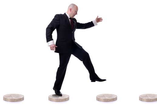 businessman leaping from coin to coin isolated on white background