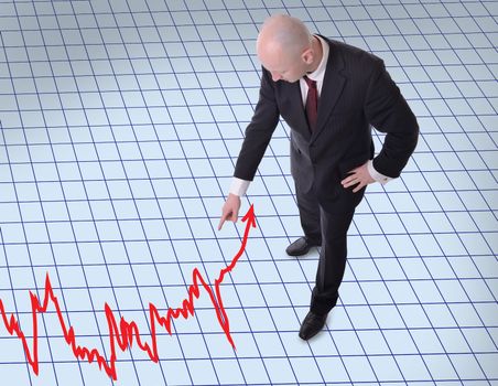 businessman pointing downwards to a graph