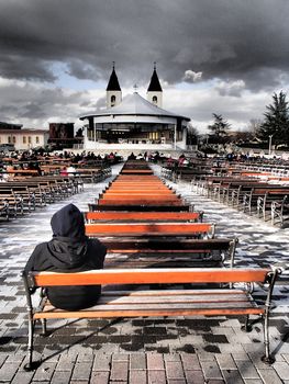 Man sitting by church in Medugorje, Bosnia