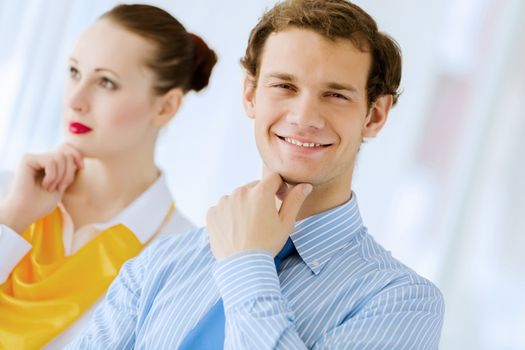 Image of businessman and businesswoman smiling joyfully