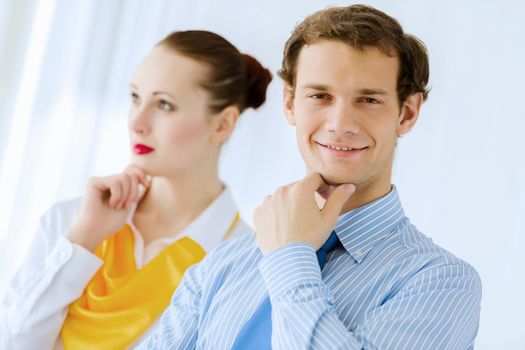 Image of businessman and businesswoman smiling joyfully