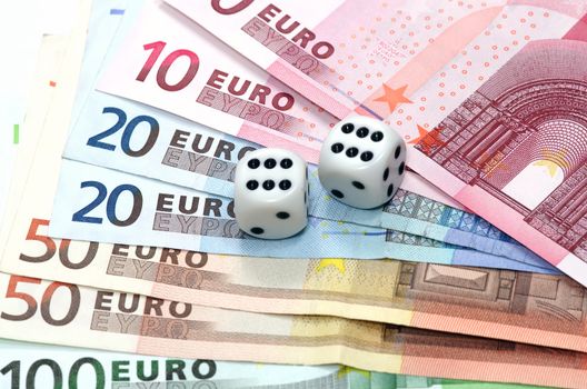 Pair of dice on money (euro banknotes)
