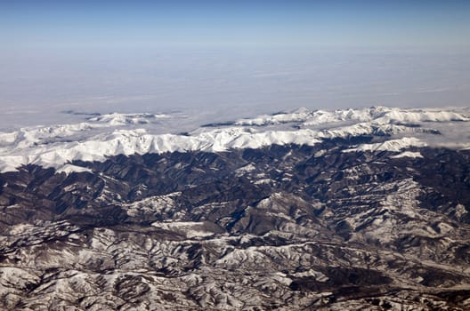 Carpathian Mountains and the blue sky, view from airplane