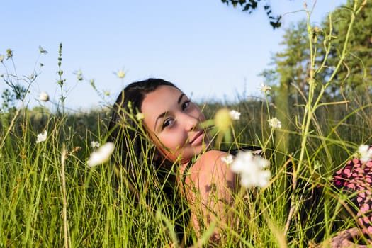 A girl of Asian appearance in the high grass