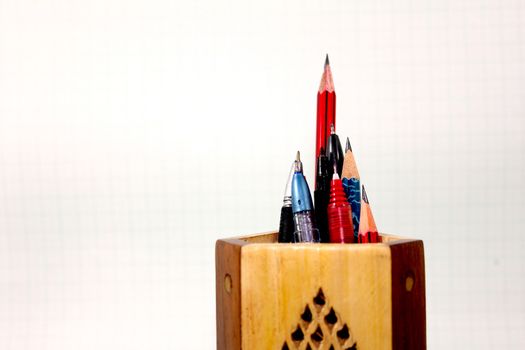 pen pencil pointed upwards in wooden stand