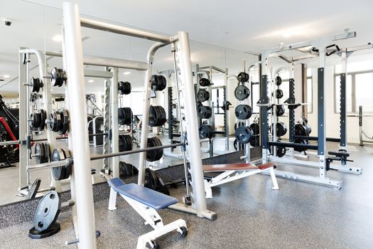 Weight lifting equipments in a club gym.