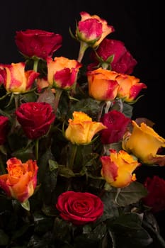 A beautifully arranged bouquet of fresh red and yellow roses
