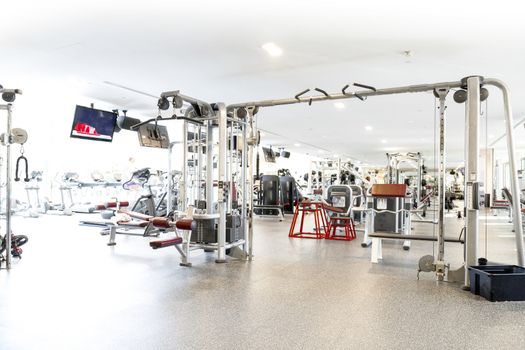 An interior shot of a club gym with all the execrise equipments