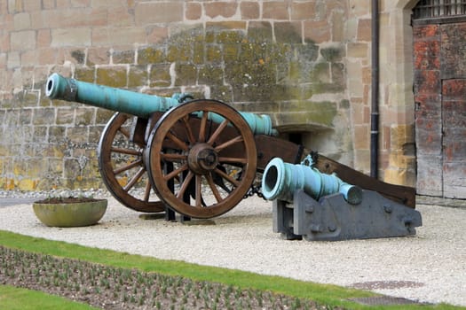 Two medieval canons standing at the entrance of middle ages castle, Morges, Switzerland