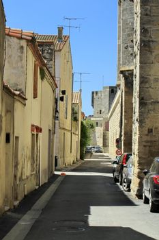 Street in Aigues-Mortes between old fortification wall and houses, provence, France