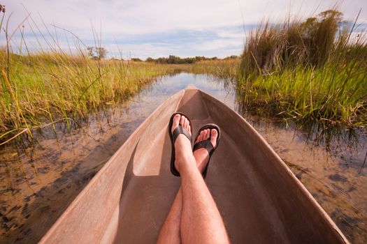 mans feet relaxing a canoe with an interesting point of view