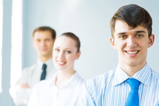 successful businessmen, a portrait of a businessman behind him are his colleagues