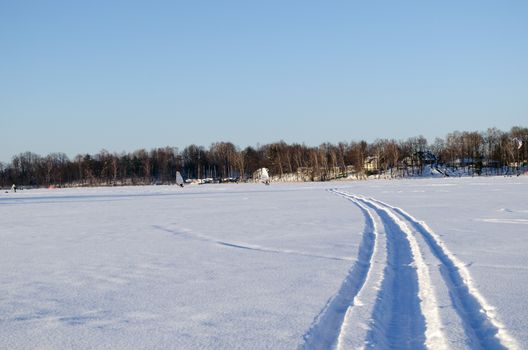 people ice sailing sport on frozen lake snow in amazing cold winter day. modern recreation hobby.