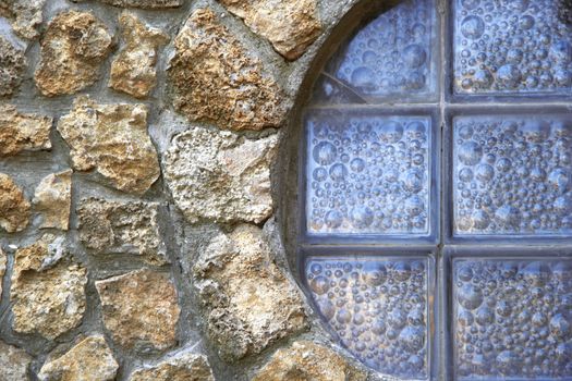 wall of a large rough stone with window
