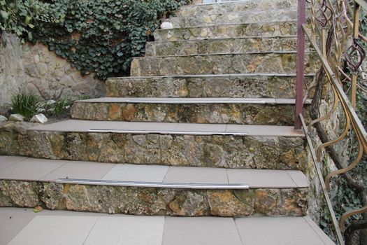 stone ladder on house with green ivy