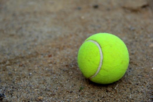 tennis ball on sandy court