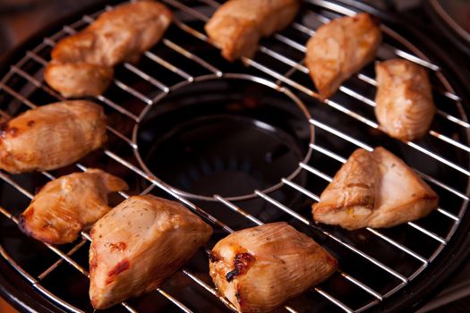 Tasty grilled chicken meat on gas grill 
