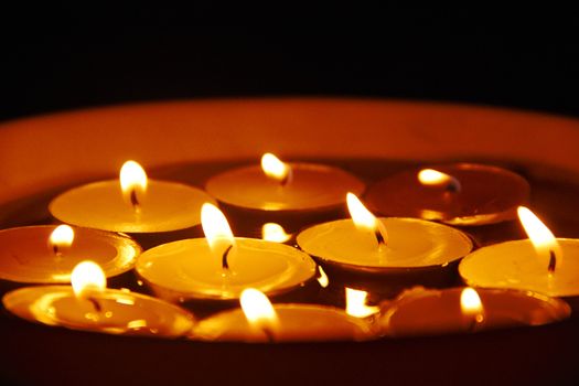 many candles in water in night