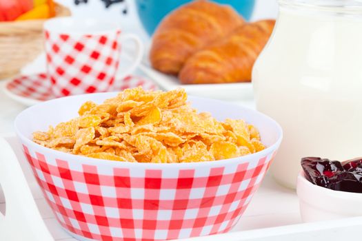 Cornflakes in a porcelain bowl on table