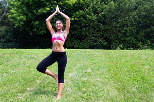 Young woman doing yoga in the park