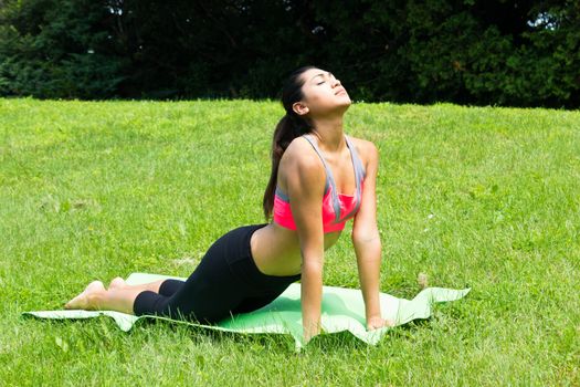 Young woman doing yoga in the park