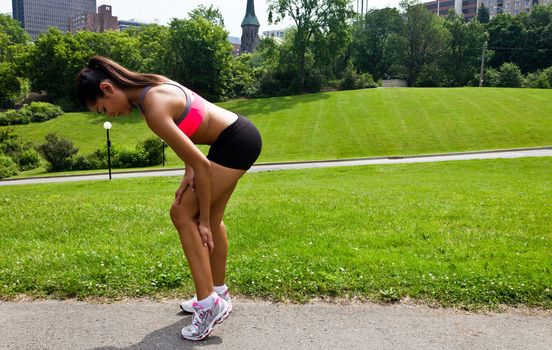 Young woman with running injury on calf