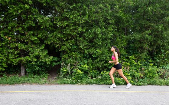 Fit woman running on the nature trail