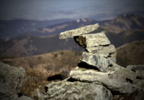 landscape in the background on the front and stone little man