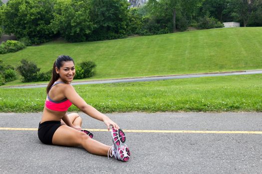 Young woman stretches before running